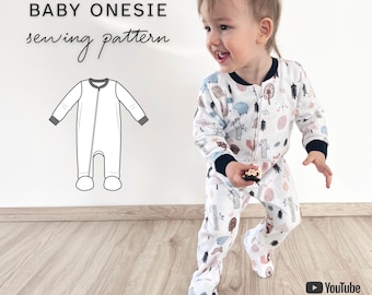 May include: A baby onesie sewing pattern featuring a white long-sleeved footed sleeper with a forest-themed print, dark cuffs, and a front zipper. The image includes a technical line drawing, the text BABY ONESIE sewing pattern, and SIZES NEWBORN - 6 YEARS.