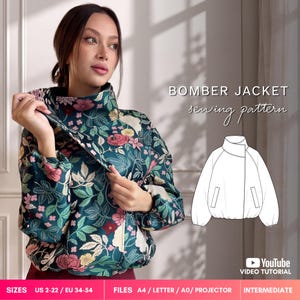 May include: A bomber jacket sewing pattern featuring a dark teal fabric with a floral print in pink, yellow, and white. The design includes a high collar, long sleeves with elastic cuffs, and a front closure. Text reads BOMBER JACKET sewing pattern, SIZES US 2-22 / EU 34-54, FILES A4 / LETTER / A0 / PROJECTOR, INTERMEDIATE.