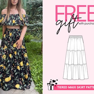 May include: A two-piece outfit consisting of an off-the-shoulder crop top and a floor-length tiered maxi skirt, both featuring a black fabric with a yellow lemon and green leaf print. A technical line drawing of the skirt is also displayed.