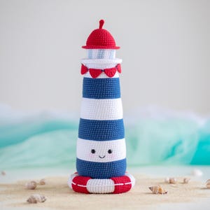 Lighthouse PDF crochet pattern. Cute lighthouse with white and navy stripes, red roof and lifebuoy. Pattern in ENGLISH.