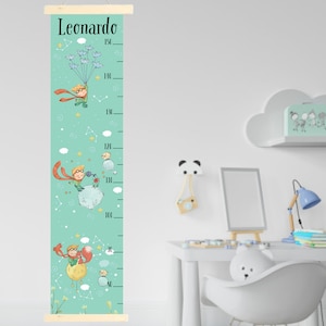 May include: A teal height chart with illustrations of a character in a red cape and a fox. The chart has a wooden top and bottom, with the name "Leonardo" at the top. Measurements are in inches, up to 150 inches.