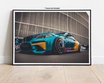 May include: A teal blue sports car with yellow and red accents and a custom paint job. The car is parked in front of a building with a grid pattern.