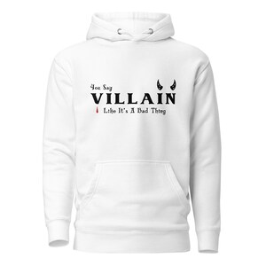 A white You Say Villain Like Its A Bad Thing hoodie with cute devil horns created by graphic apparel company Midnight Gypsy Designs as part of their Dark Academia clothing and Bookish Merch clothing line.