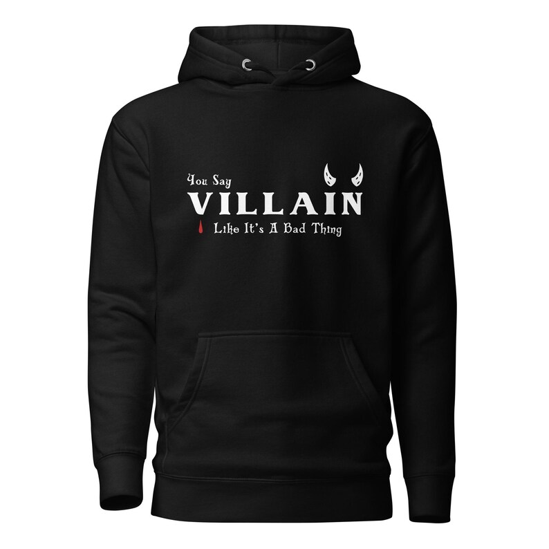 A black You Say Villain Like Its A Bad Thing hoodie with cute devil horns created by graphic apparel company Midnight Gypsy Designs as part of their Dark Academia clothing and Bookish Merch clothing line.