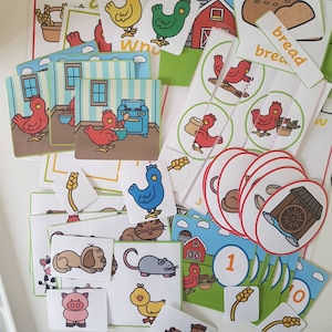 May include: A collection of colorful educational cards featuring farm animals, chickens, and scenes. The cards include illustrations of a red barn, a blue oven, and the word "bread". The cards are designed for learning and play.
