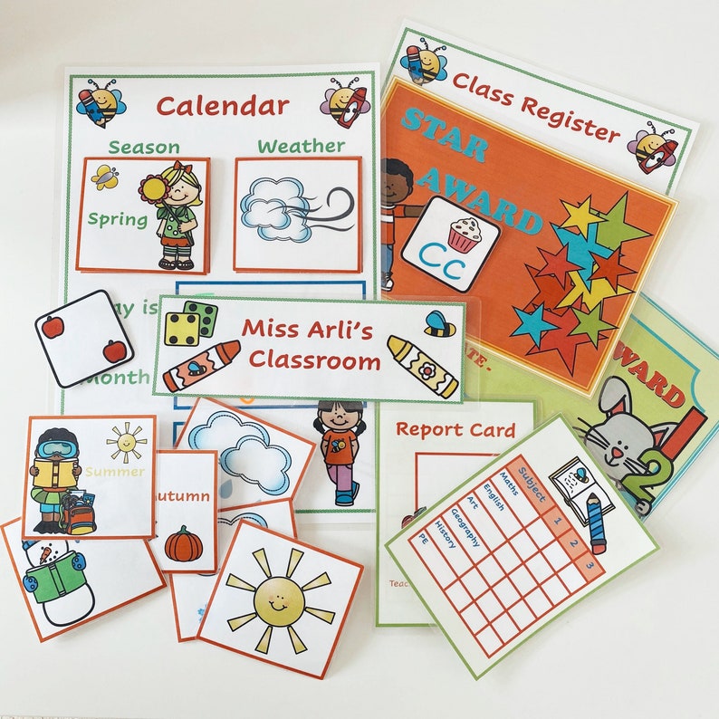 May include: A set of colorful classroom organization charts and cards. The charts include a calendar, class register, and report card. The cards feature images of seasons, weather, and classroom activities. The text on the charts includes "Calendar", "Season", "Weather", "Class Register", "STAR AWARD", "Miss Arli's Classroom", "Report Card", and "Subject".