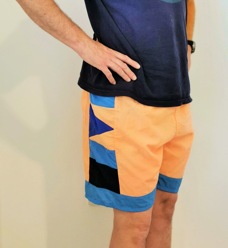 Vintage shorts UK 10-14 Vintage neon orange unisex shorts with blue geometric side borders