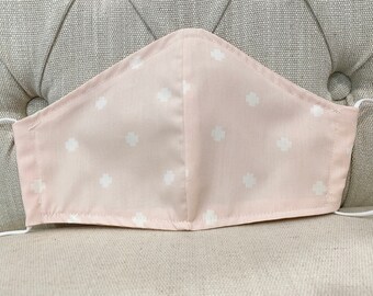 Light pink double layer facemask with adjustable ear loops. Breathable