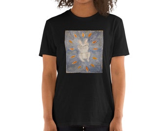 May include: A black t-shirt with a white rabbit illustration on a blue background. The rabbit is surrounded by orange leaf-like shapes.