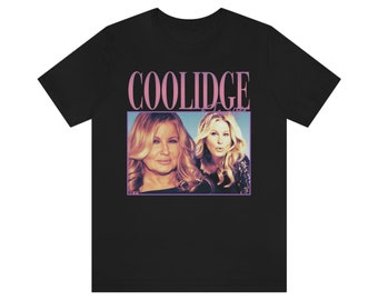 May include: Black t-shirt with a pink graphic of two women and the text "COOLIDGE" in pink.