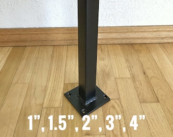 May include: Black metal square post with a square base. The post is 4 inches tall and the base is 4 inches wide. The post is standing on a wooden floor. The numbers 1, 1.5, 2, 3, and 4 are written on the floor in front of the post.