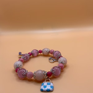 Elegance Defined: Barbie-Inspired Stretch Bracelet. Pink jade and tiger eye beads, chic charms, silver accents. Perfect gift for her!