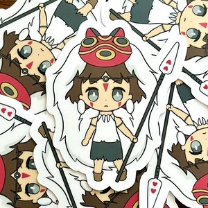 May include: A sticker featuring a cartoon character with brown hair, a red mask, and a white fur-like collar. The character is holding two spears with heart-shaped details. The sticker has a white border.