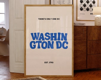 May include: A framed poster with a white background and a blue graphic that says "WASHIN GTON DC" with the text "THERE'S ONLY ONE DC" above it and "EST. 1790" below it.