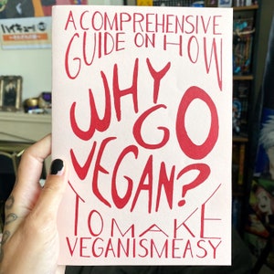 May include: A pink pamphlet with the title "A Comprehensive Guide on How Why Go Vegan? To Make Veganism Easy" in red text.