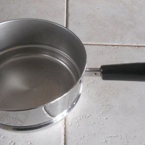 May include: A handmade, wooden cutting board with a natural wood grain. The board features a juice groove and a handle for easy carrying. Dimensions are approximately 18 inches long, 12 inches wide, and 1 inch thick.