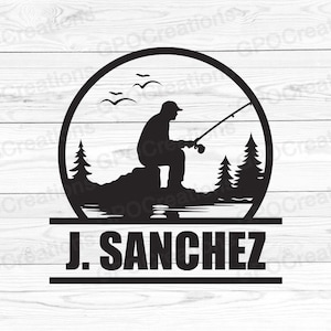 May include: Black and white silhouette of a person fishing in a circle with trees and birds. The text "J. SANCHEZ" is below the circle.