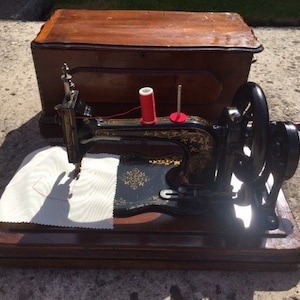 Antique Bradbury & Co. Family Fiddle Base Sewing Machine c.1890 with coffin case and instruction manual
