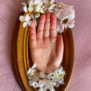 hand with framed flowers