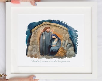 May include: A framed watercolor print depicting the Nativity scene. The artwork features Mary, Joseph, and baby Jesus in a stable, with a stone exterior and a dark blue sky. The text at the bottom reads, "For the baby was born to us - The Son is given to us."