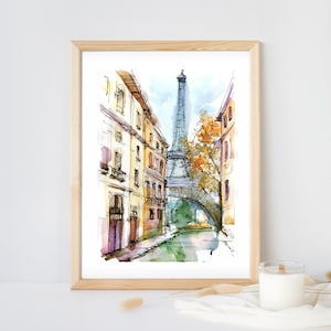 Puede incluir: Una pintura de acuarela de una escena de calle parisina con la Torre Eiffel en el fondo. La calle está bordeada de edificios y hay un puente sobre un canal. La pintura está hecha en un estilo suelto e impresionista.
