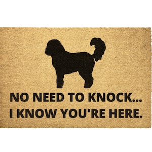 May include: A brown coir doormat with a black silhouette of a dog and the text "NO NEED TO KNOCK... I KNOW YOU'RE HERE."