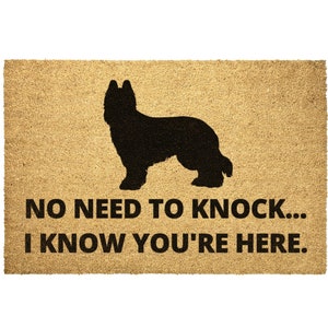 May include: A brown coir doormat with a black silhouette of a Briard dog and the text "NO NEED TO KNOCK... I KNOW YOU'RE HERE."