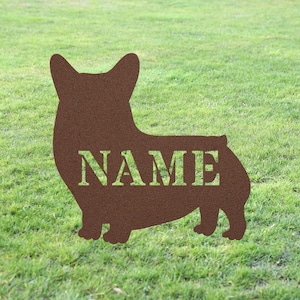 May include: Brown metal silhouette of a corgi dog with the word "NAME" in white lettering.