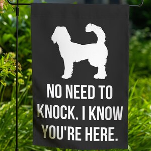 May include: Black garden flag with a white silhouette of a dog and the text "NO NEED TO KNOCK. I KNOW YOU'RE HERE."