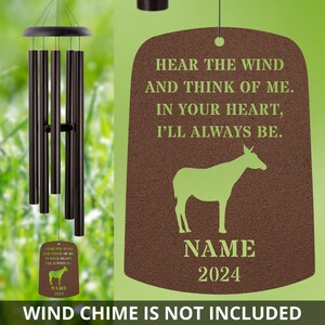 May include: A brown wooden sign with a green silhouette of a donkey and the text "HEAR THE WIND AND THINK OF ME. IN YOUR HEART, I'LL ALWAYS BE."  The sign also includes the text "NAME 2024".