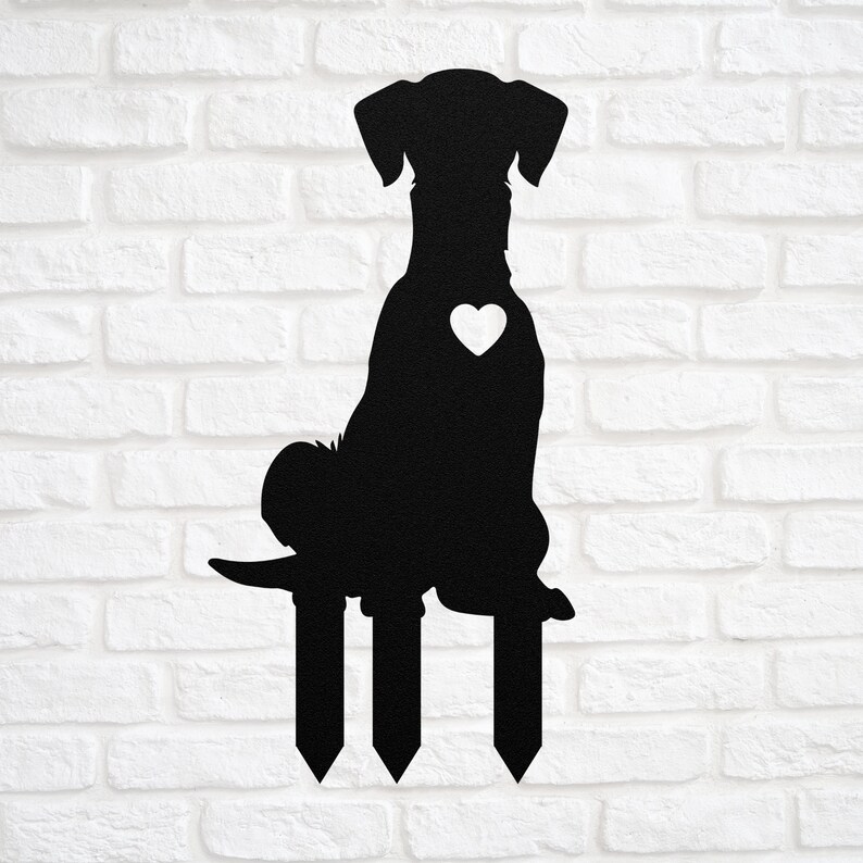 May include: Black metal silhouette of a dog sitting on three stakes. The dog has a heart on its chest.