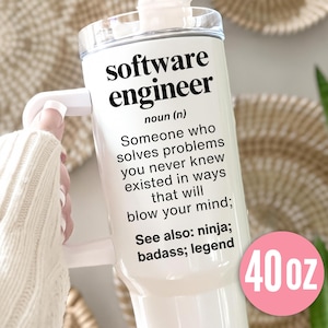 May include: White 40 oz tumbler with a handle, featuring the text "software engineer" and a definition. The tumbler includes the words "ninja, badass, legend" and a pink circle with "40 oz".