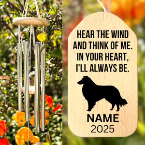May include: A wooden wind chime with silver tubes and a wooden top. A wooden tag with the text "HEAR THE WIND AND THINK OF ME. IN YOUR HEART, I'LL ALWAYS BE." and a black silhouette of a dog. The tag also includes the word "NAME" and the number "2025".