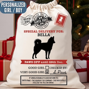 May include: Cream-colored Christmas gift sack with a black dog silhouette and the text "Special Delivery for: BELLA". Includes holiday-themed stamps and text: "Paws Off until 25th Dec."