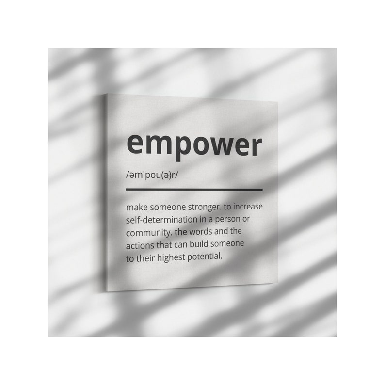 May include: A black and white print with the word "empower" in bold, followed by the phonetic pronunciation and a definition of the word. The definition explains that empower means to make someone stronger and increase self-determination in a person or community.