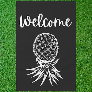 May include: Black welcome garden flag with a white pineapple design. The pineapple is stylized with a detailed pattern and has a long, spiky stem.