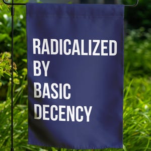 May include: A blue garden flag with white text that reads "RADICALIZED BY BASIC DECENCY".