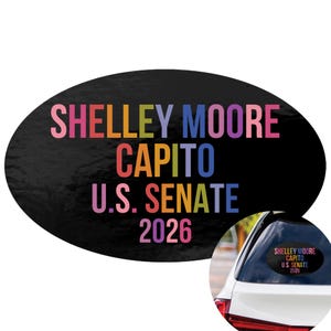 May include: An oval-shaped black car decal featuring multi-colored text that reads SHELLEY MOORE CAPITO U.S. SENATE 2026. The letters appear in various shades of pink, orange, yellow, green, blue, and purple against the dark background.