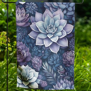 May include: A garden flag featuring a close-up of a variety of succulents in shades of purple, blue, and green. The succulents are arranged in a dense pattern, creating a vibrant and textured design.