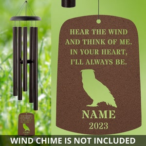 May include: A brown metal memorial wind chime with a green owl silhouette and the text "Hear the wind and think of me. In your heart, I'll always be."  The chime also includes a space for a name and the year 2023.