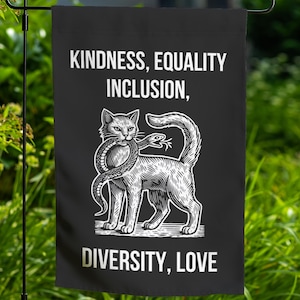 May include: Black garden flag with a white cat holding a snake in its mouth. The text on the flag reads "Kindness, Equality, Inclusion, Diversity, Love".