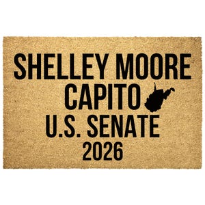 May include: A rectangular tan coir doormat featuring black text that reads SHELLEY MOORE CAPITO U.S. SENATE 2026. To the right of the word CAPITO is a solid black silhouette of the state of West Virginia. The mat has a coarse, fibrous texture.