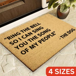 May include: A brown coir doormat with the text "RING THE BELL SO I CAN SING YOU THE SONG OF MY PEOPLE" - THE DOG. The doormat is available in 4 sizes.