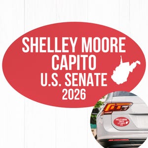 May include: A red oval bumper sticker with white text that reads "Shelley Moore Capito U.S. Senate 2026" and a white outline of West Virginia. The sticker is shown on a car.