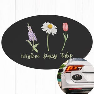 May include: Oval-shaped black and white sticker with illustrations of a foxglove, daisy, and tulip. The text "Foxglove Daisy Tulip" is written in gold lettering below the flowers.