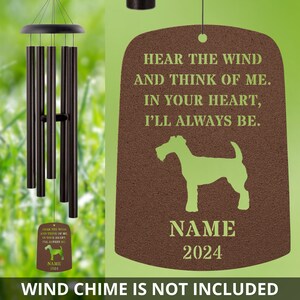 May include: A brown wooden sign with a green silhouette of a wirehaired fox terrier dog. The sign reads "Hear the wind and think of me. In your heart, I'll always be."  The sign also includes the text "NAME 2024".