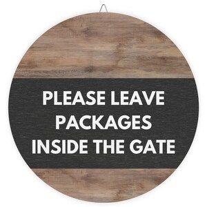 May include: Round wooden sign with a black background and white text that reads "Please Leave Packages Inside The Gate".