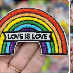 May include: A rainbow-colored embroidered patch with the text "LOVE IS LOVE" in black lettering. The patch is on a white background.