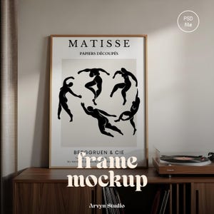 May include: A framed art print featuring a black and white Matisse design with the text "MATISSE PAPIERS DÉCOUPÉS". The artwork is displayed on a wooden cabinet, next to a record player. The words "frame mockup" are at the bottom.
