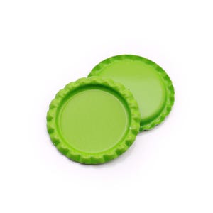 May include: Two circular bottle caps with a smooth, solid lime green finish. Each cap features a distinct crimped, scalloped edge design typical of metal bottle closures, presented in a clean, simple arrangement against a plain white background.